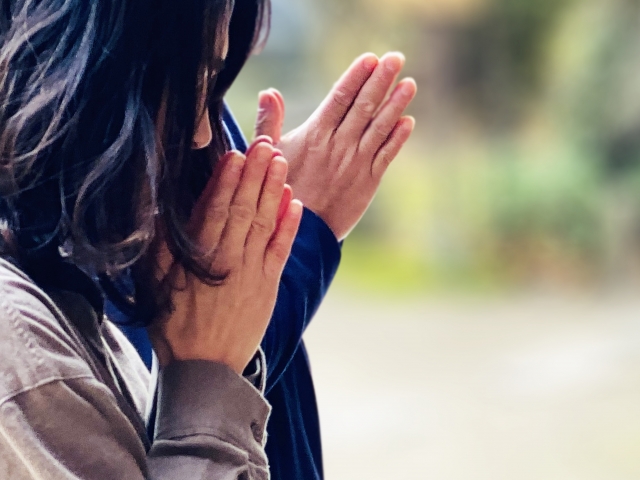 手を合わせる女性